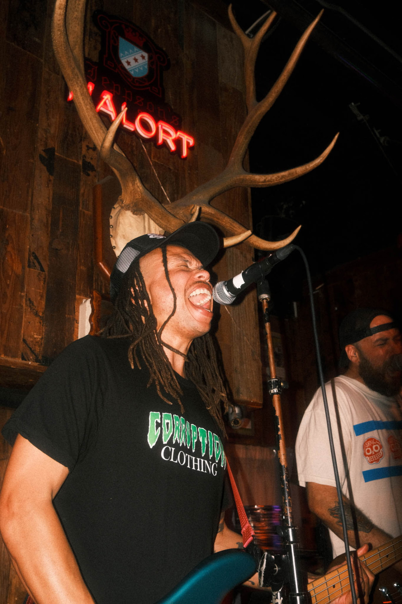 Singer at a live show wearing a custom screen-printed band t-shirt by CC Print