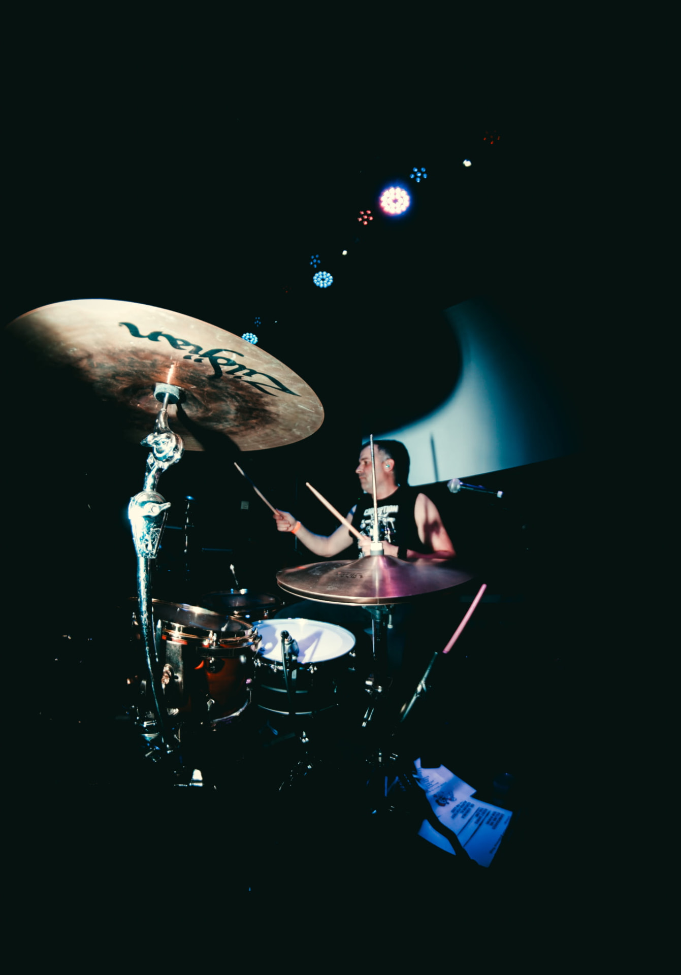Drummer mid-set wearing a custom-printed sleeveless band shirt by CC Print
